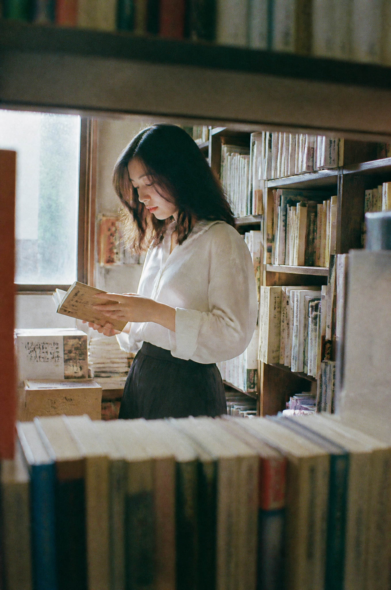 Original preview image for the prompt “A beautiful Japanese woman browsing old books inside a ti...” — creator credit: user_6245000c